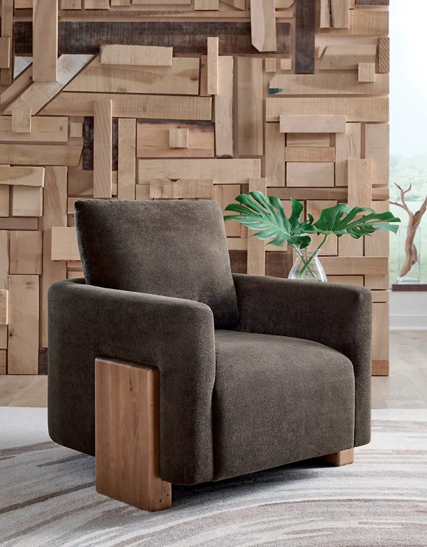 Brown accent chair against a wood-block feature wall