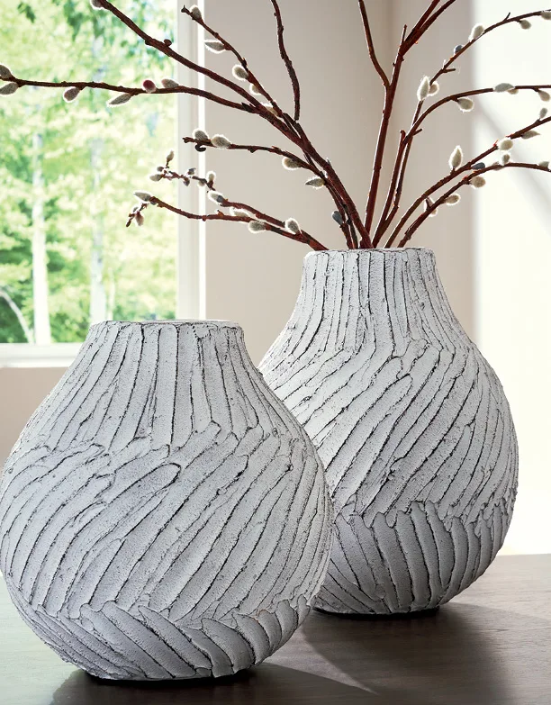 Textured white vases with budding branches