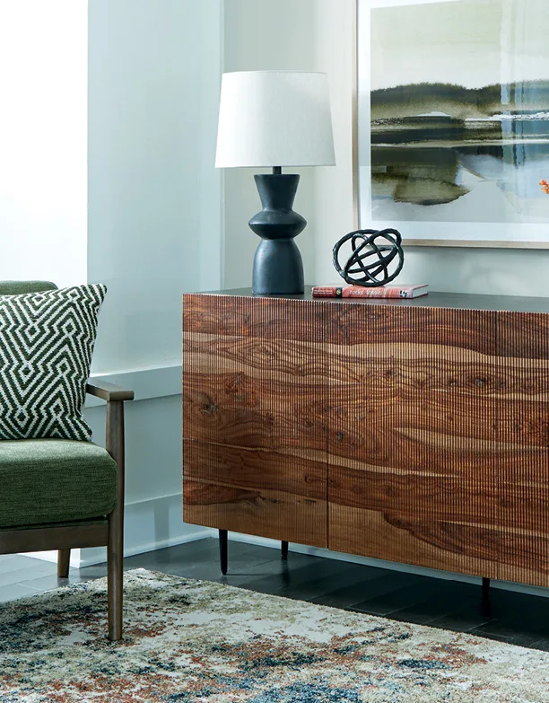 Walnut console with a sculptural lamp in a styled living room