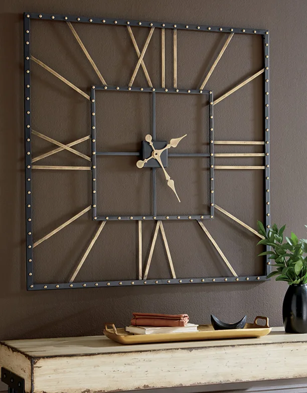 Square Roman-numeral wall clock above a styled console