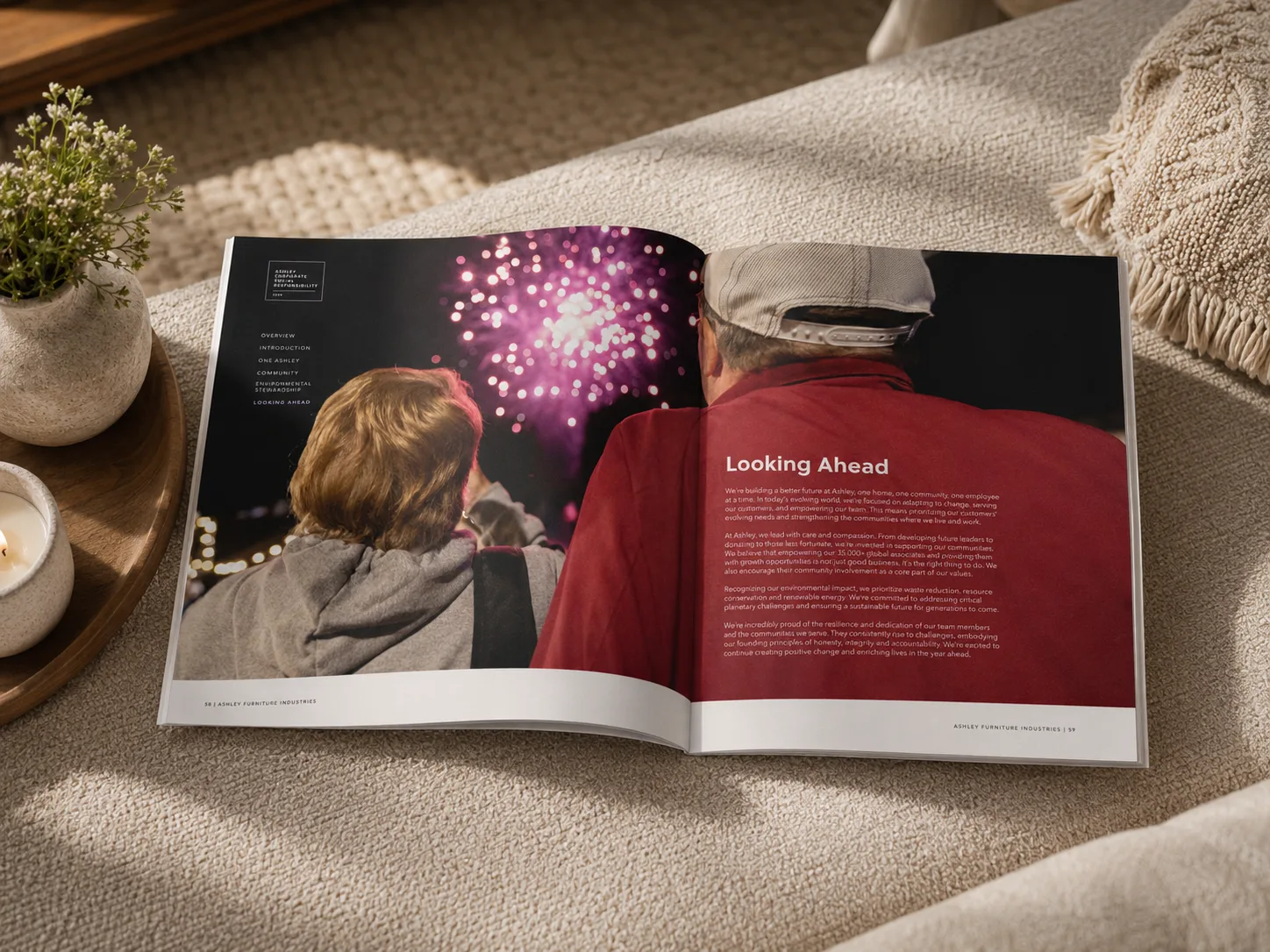 Ashley CSR report shown open to a Looking Ahead spread on a textured couch.